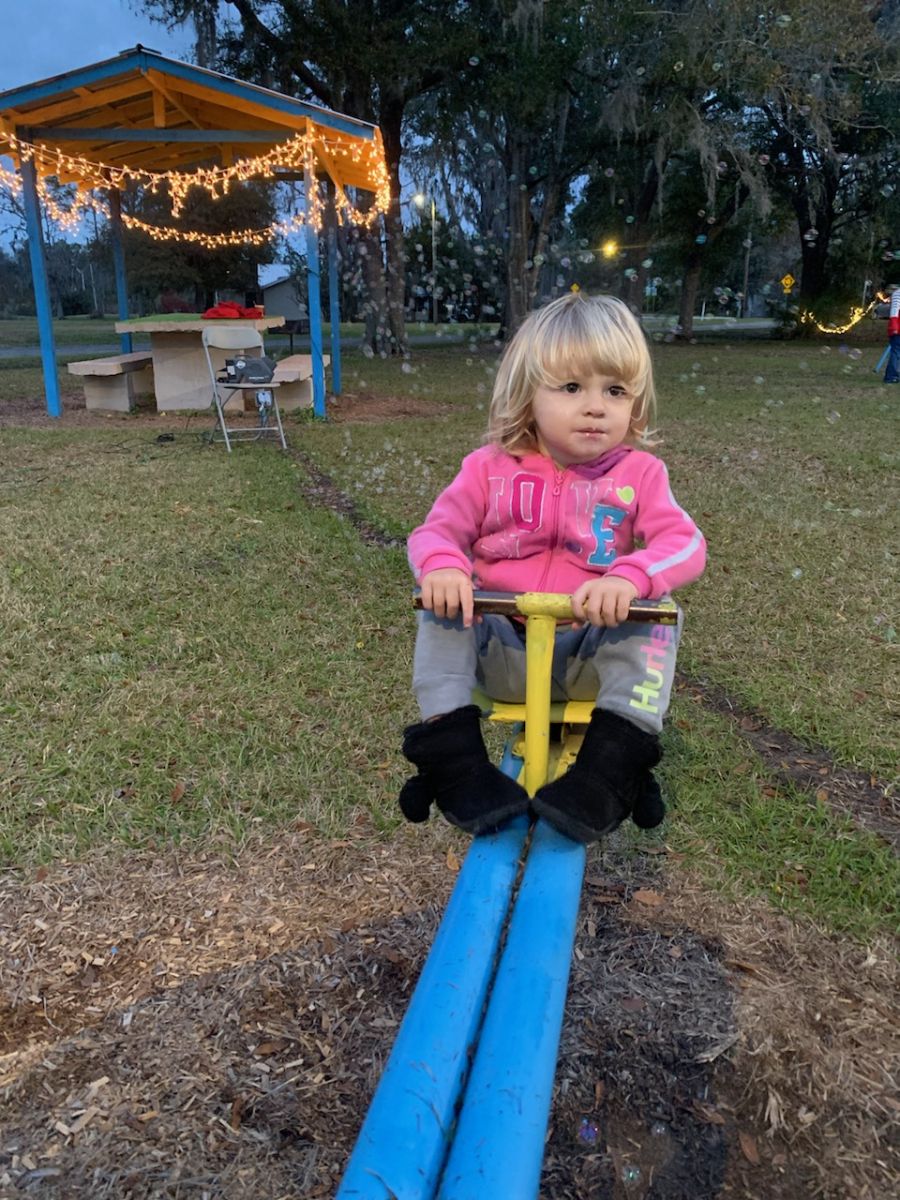 child playing on seesaw at park