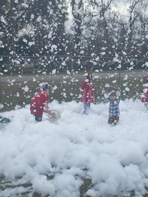 children playing at park in snow foam