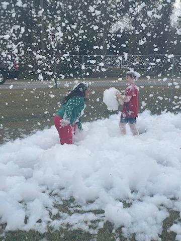 children playing at park in snow foam