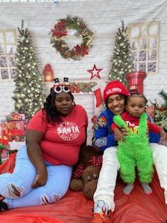 two people and child at park christmas event 