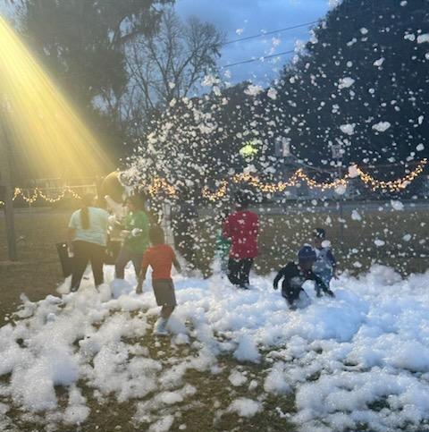 group of kids playing in foam snow