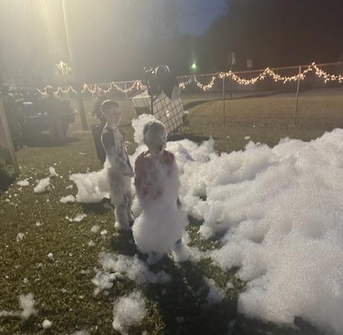 kids playing in snow foam at park event