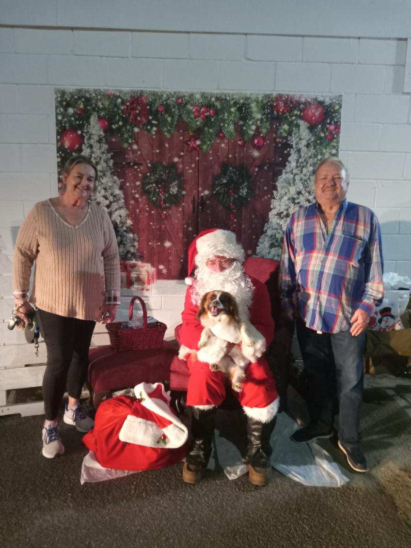 Santa, two people and a dog 